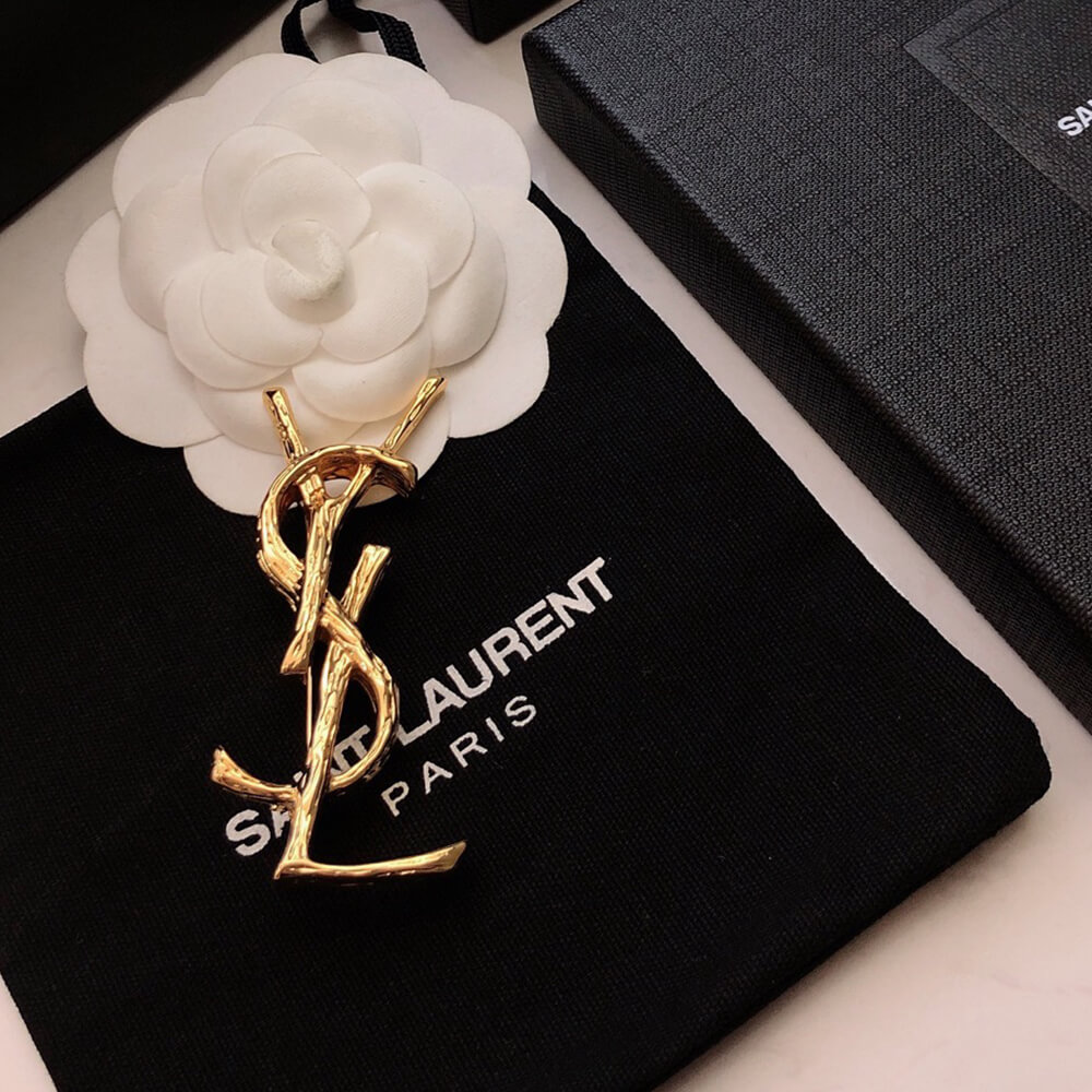 YSL CASSANDRE BROOCH IN METAL