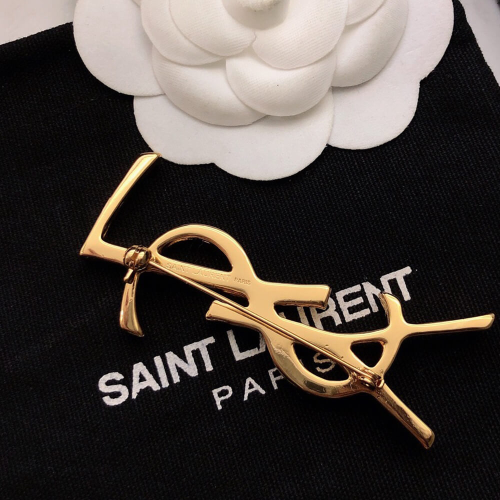 YSL CASSANDRE BROOCH IN METAL