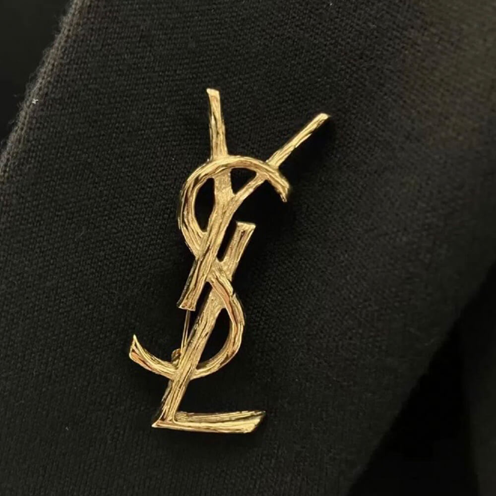YSL CASSANDRE BROOCH IN METAL